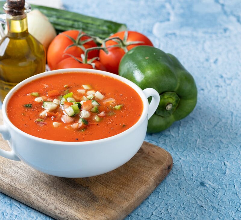 with vegetables in the background gazpacho soup