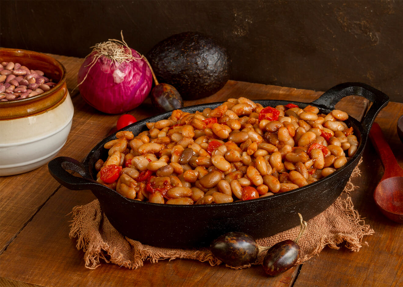 Kuru Fasulye (White Bean Stew) in a metal pan with onion on the table